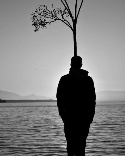 Silhouette of a person meditating at sunrise.